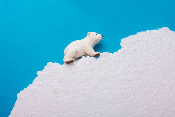 Fake Polar bear cub  on fake snow and sea background environment - Foto, Imagen