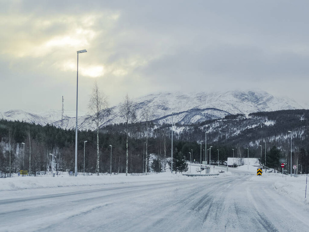 Driving through snowy white road and winter landscape in Norway. - 写真・画像