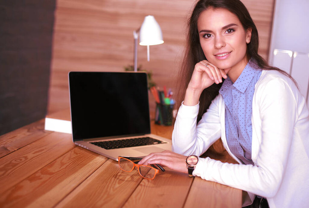 Young female working sitting at a desk. - Foto, Imagem