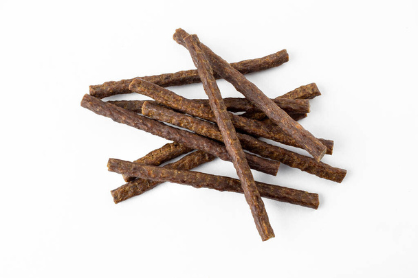 a group of natural formed dog treats, beef, chicken, pork, lamb meat sticks on white background - Photo, Image