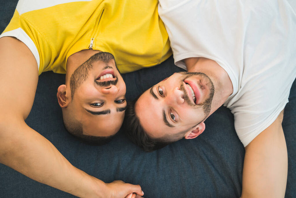 Gay couple laying down on the floor. - Fotoğraf, Görsel