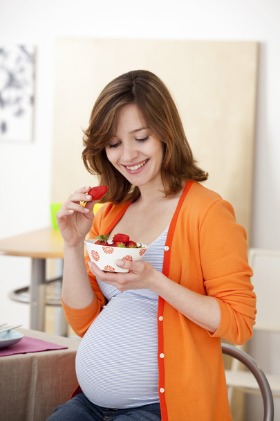 PREGNANT WOMAN EATING - Foto, imagen