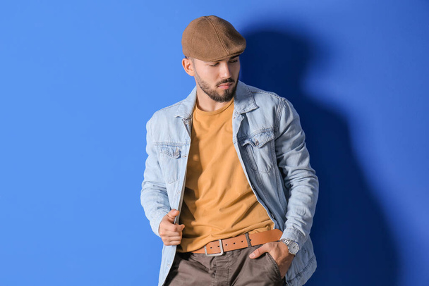 Fashionable young man on color background - Photo, Image