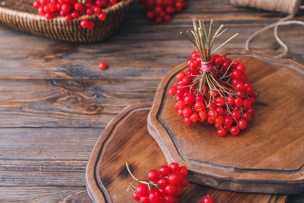 Boards with fresh viburnum berries on table - Φωτογραφία, εικόνα
