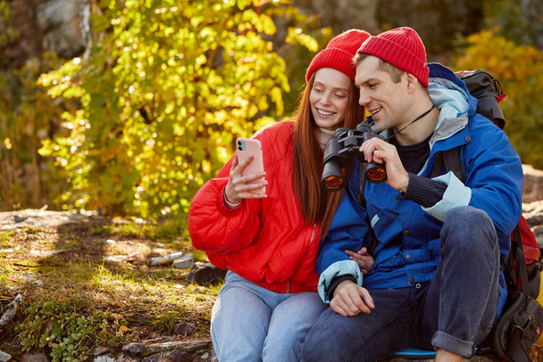 caucasian couple rest on mountains , use smartphone - Photo, image