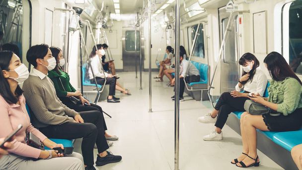 Crowd of people wearing face mask on a crowded public subway train travel - Photo, Image