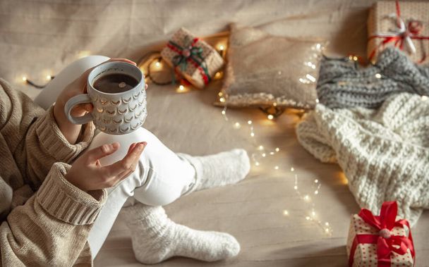 A woman is holding a beautiful cup with a hot drink. Cozy winter concept. - Fotoğraf, Görsel