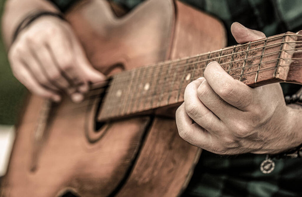 Male musician playing guitar, music instrument. Mans hands playing acoustic guitar, close up. Acoustic guitars playing. Music concept. Guitars acoustic - Photo, Image