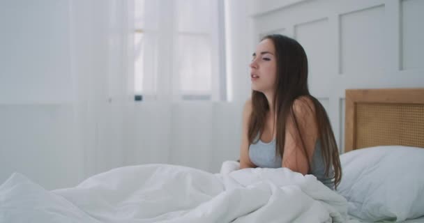 Young casual woman is having stomach ache. Her menstrual cramps are too painful to go to work. It feels like a storm raging inside my body. - Footage, Video
