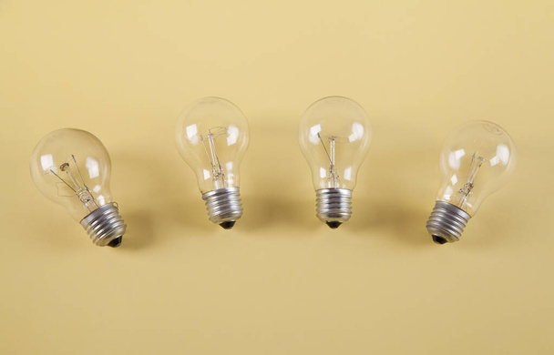 Light bulbs isolated on a yellow background. - Фото, изображение