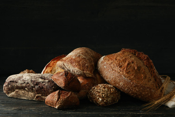 Different fresh bakery products on wooden background - Φωτογραφία, εικόνα