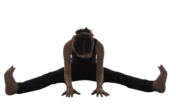 Woman doing Wide Angle Seated Forward Bend Pose in Silhouette - Photo, Image