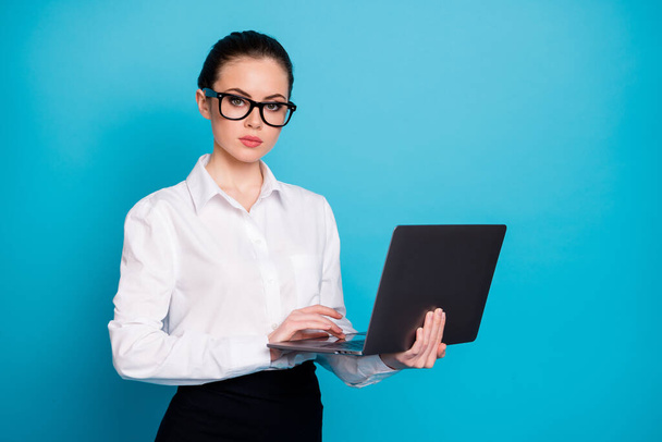Portrait of nice attractive skilled serious smart lady holding in hands laptop isolated over vibrant blue color background - Φωτογραφία, εικόνα