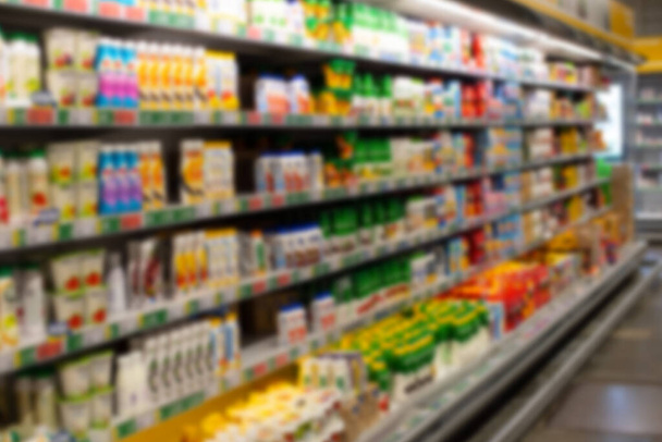 Defocus background grocery store shelves dairy department. Blurred photo of supermarket no people for design - Photo, Image