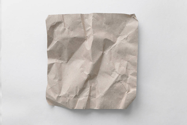 Brown wrinkle recycle paper background. Crumpled brown paper on white background, can use text banners products or business cards. - Photo, Image