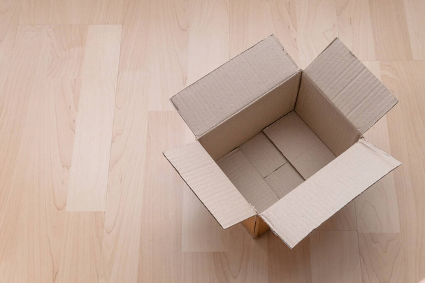 Empty open rectangular cardboard box on wood background. Shopping online object background. Shipping parcel object. - Foto, Imagen