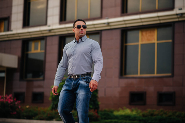 Young successful man near an office building. Business - 写真・画像