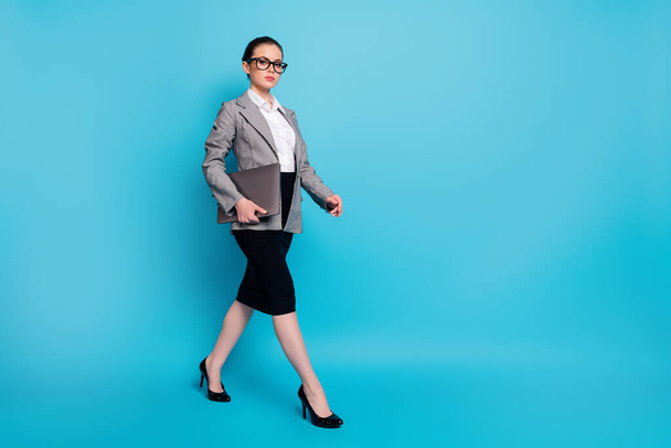Full length body size view of nice attractive lady leader carrying laptop going on meeting isolated on bright blue color background - Photo, Image