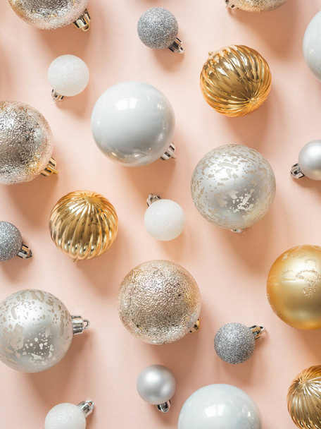 Flat lay of various christmas balls of on a pastel peach background. Top view. - Foto, imagen