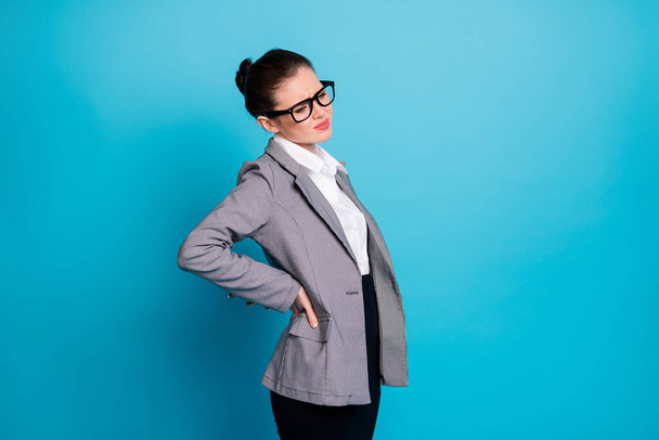 Profile side view portrait of sick classy lady employee bending feeling bad touching spine isolated on bright blue color background - Fotografie, Obrázek