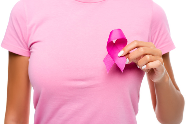 Cropped view of young woman holding ribbon of breast cancer awareness near chest isolated on white - Valokuva, kuva