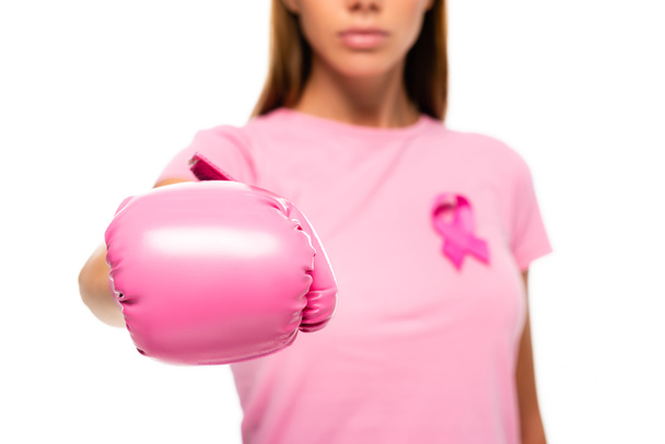 Cropped view of woman in boxing glove and pink ribbon of breast cancer awareness on blurred background isolated on white - Фото, зображення