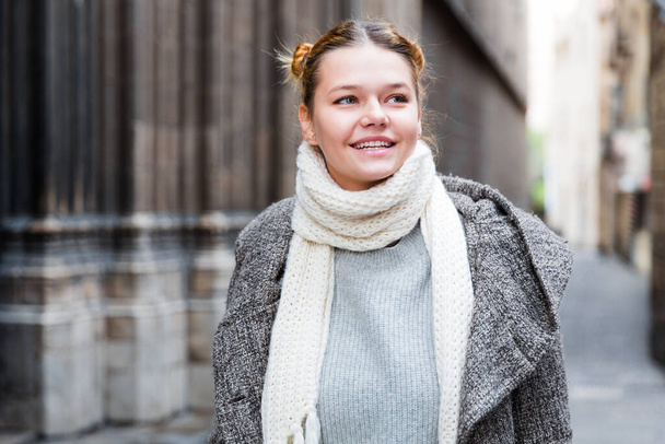 positive girl teenager in the city in scarf - Zdjęcie, obraz