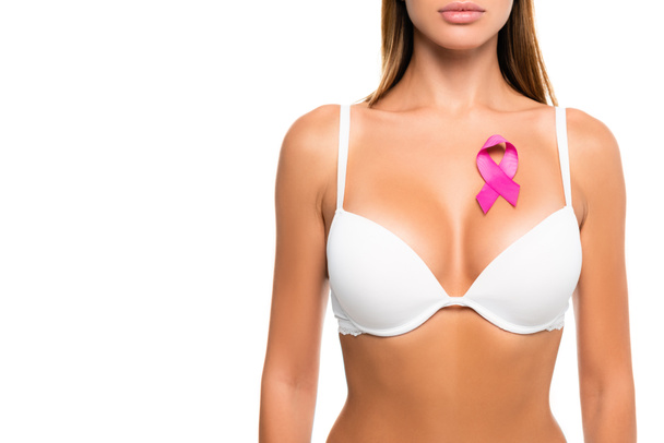 Обрезанный вид ленты рака молочной железы осведомленности на груди женщины в бюстгальтере изолированы на белом - Фото, изображение