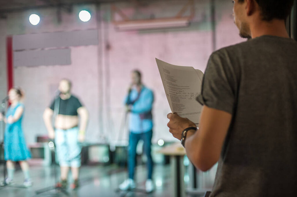 Behind the scene. Director of the play rehearses the play with the actors according to the script - Fotografie, Obrázek
