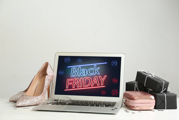 Composition with laptop and gifts on table against white background, space for text. Black Friday sale - Valokuva, kuva