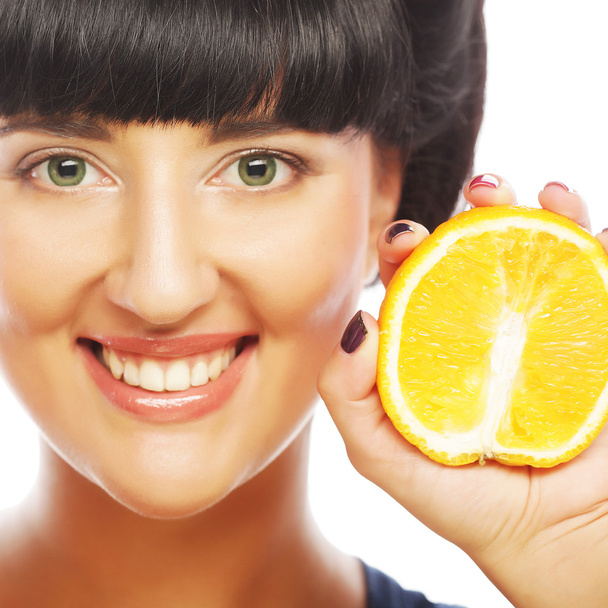 Young woman with oranges in her hands - Foto, imagen