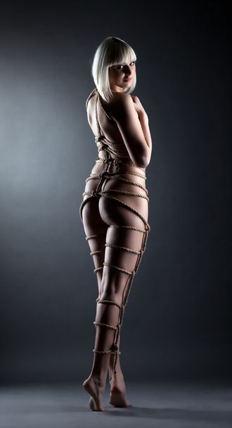 Cute slim blonde posing with ropes around her body - Zdjęcie, obraz