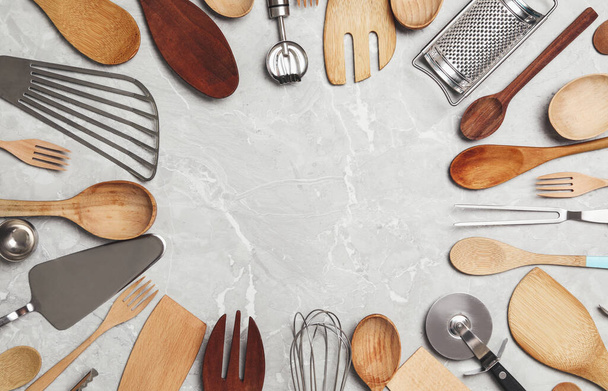 Frame of cooking utensils on grey marble table, flat lay. Space for text - Φωτογραφία, εικόνα