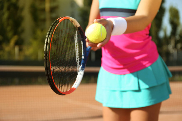 Sportswoman preparing to serve tennis ball at court, closeup - Fotoğraf, Görsel