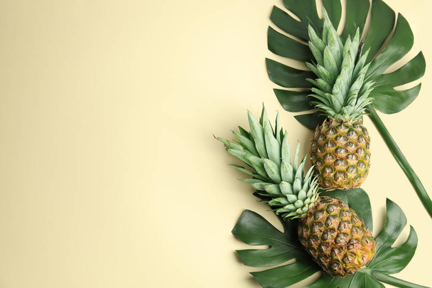 Fresh ripe juicy pineapples on beige background, flat lay. Space for text - Фото, зображення