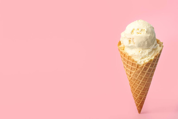 Delicious ice cream in waffle cone on pink background. Space for text - Фото, изображение