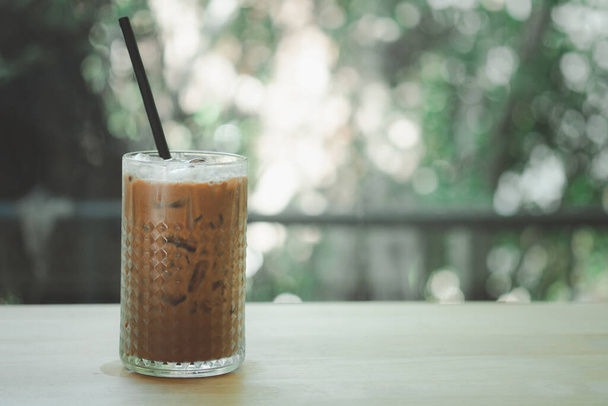 A glass of iced coffee Mocha with black straw on the table - Zdjęcie, obraz
