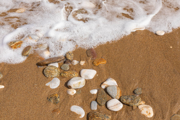 Sfondo di pietre marine. Spiaggia sabbiosa con onda. Grecia, Europa. - Foto, immagini