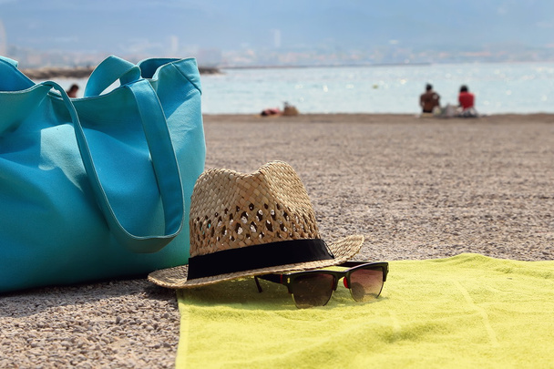 Hat, beach bag and the glasses on the rug - Photo, Image