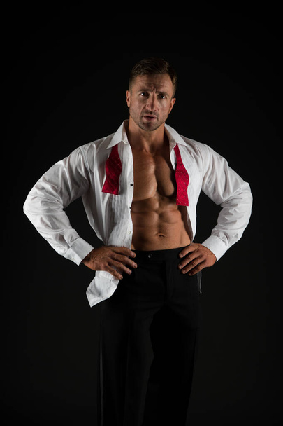 Too fit is style for him. Stylish man show six pack abs in open shirt dark background. Professional wardrobe. Wedding dress code. Groom fashion. Formal style. Wellness and health. Sport and fitness - Fotoğraf, Görsel