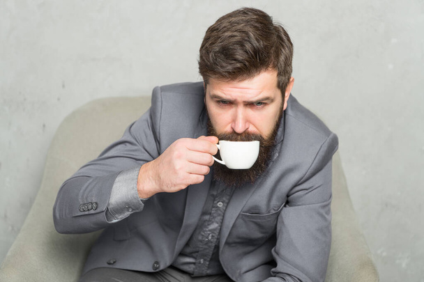Man handsome bearded businessman hold cup of coffee. Coffee break concept. Business people. Best coffee served for him. Attractive pensive manager in thoughtful mood. Coffee cup. Recharge and reload - Photo, image