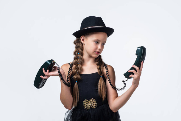 stylish kid speak on retro phone isolated on white, technology - Foto, afbeelding