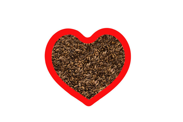 Milk thistle seeds in heart shape red frame isolated on white background - Photo, Image