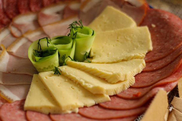 festive slicing of cheese, sausage, meat for the holiday. treats for the guests. selective focus - Photo, Image