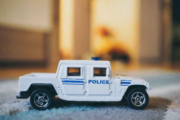 POZNAN, POLAND - Nov 13, 2016: White Siku toy model Police vehicle on a carpet floor - Foto, afbeelding