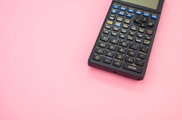 A closeup shot of a calculator on a pink background - Fotoğraf, Görsel