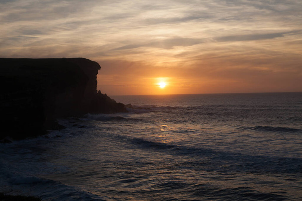 An amazing shot of a beautiful coastal cliff on a seaside sunset background - Fotografie, Obrázek