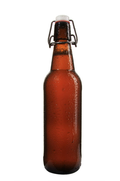 A vertical shot of a cold wet bottle of beet isolated on a white background - Photo, image