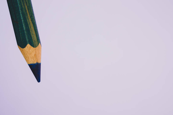 A closeup of a blue sharp pencil isolated on a gray background - Zdjęcie, obraz