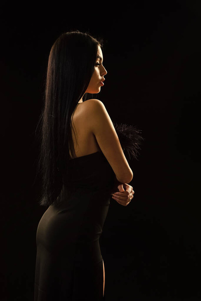 Mystery concept. Mysterious fashion model. Sexy girl in darkness. Nude shoulders. Girl with long hair. Impeccable appearance. Mysterious fashion lady. Attractive woman. Aesthetics female beauty - Foto, imagen